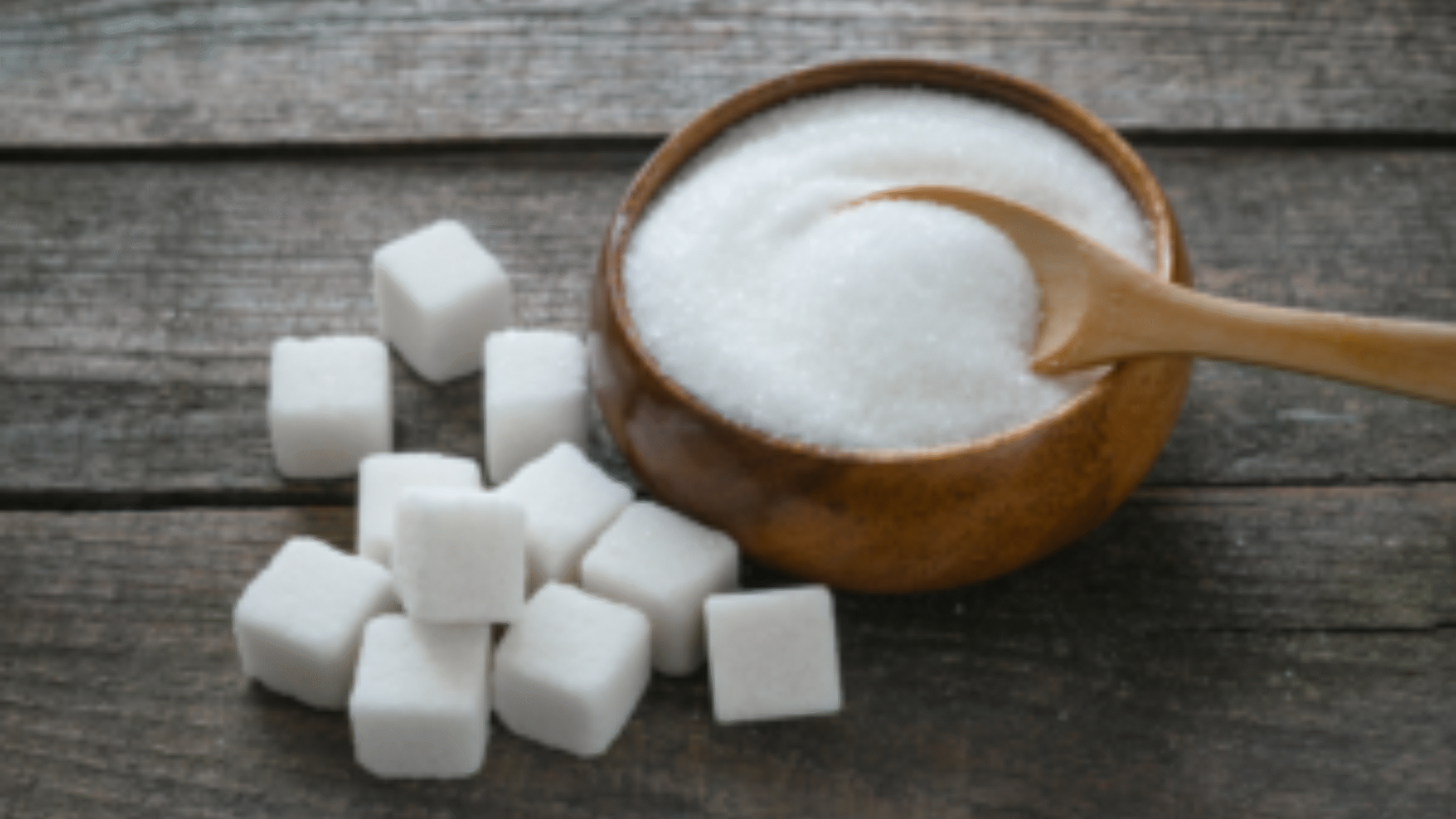 full bowl of sugar and sugar cubes on table