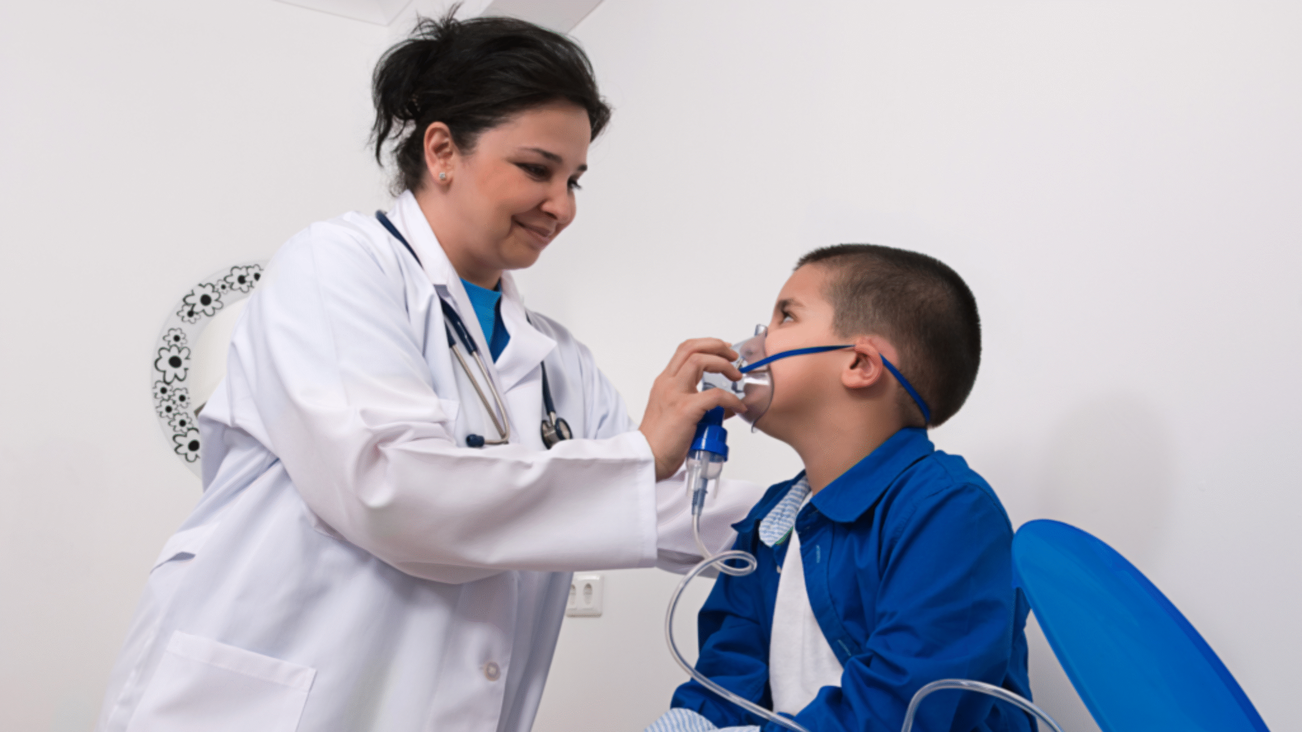 physician helps pediatric patient with respiratory breathing