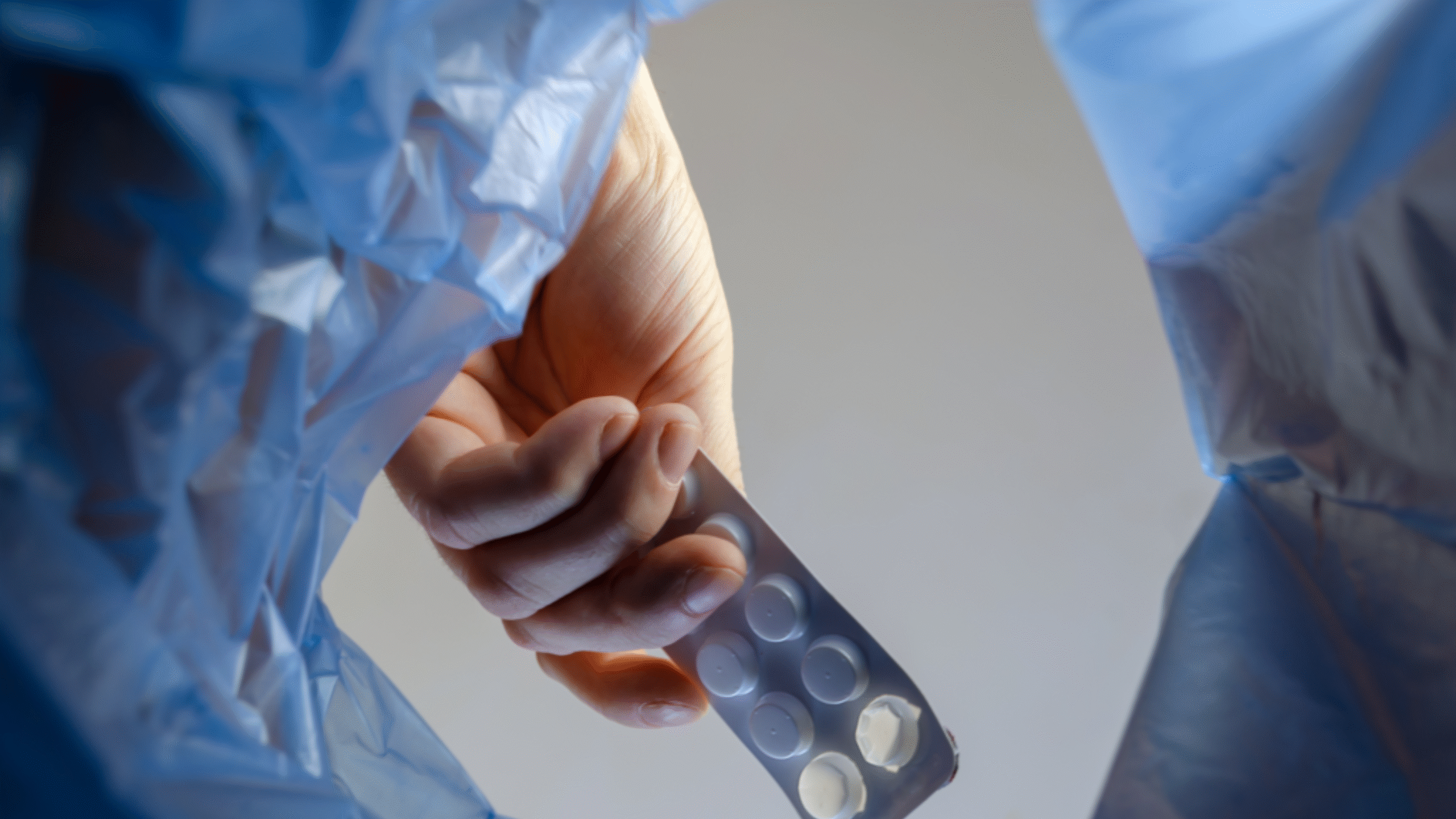Person throws away old medication into trashcan