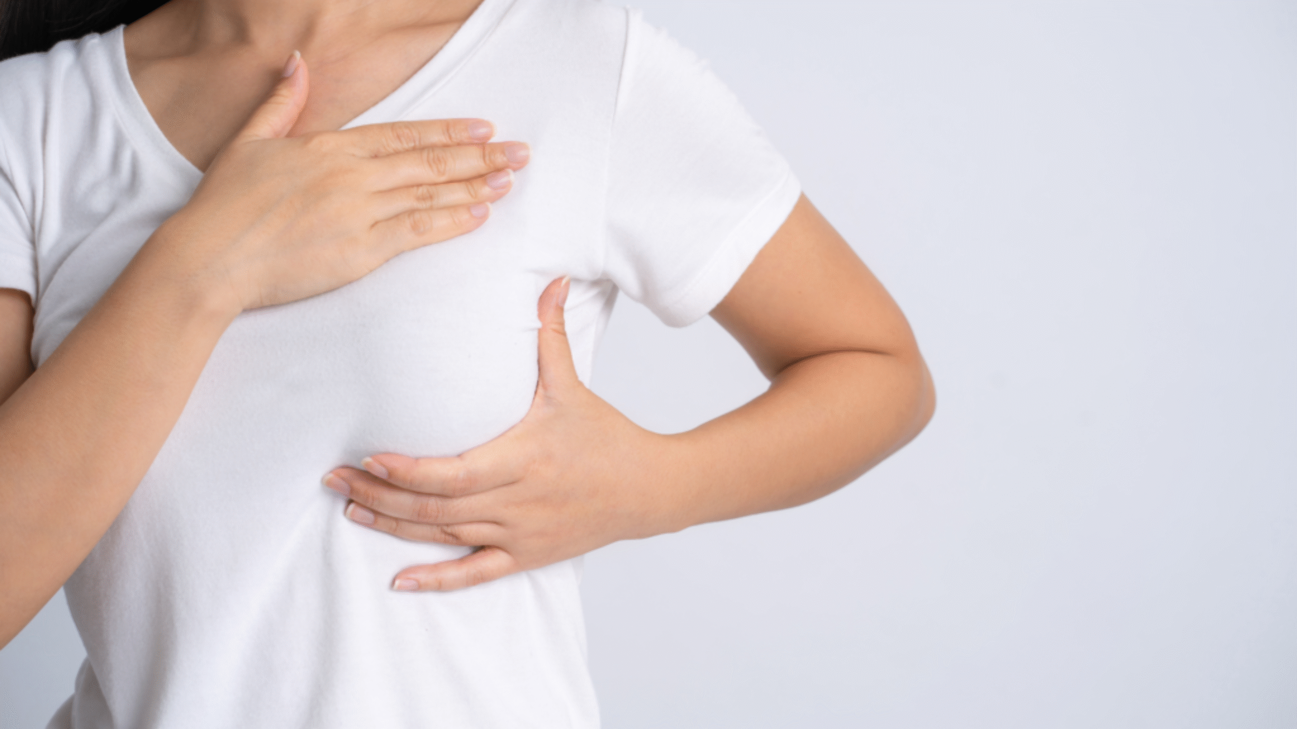 Woman performs self-breast exam