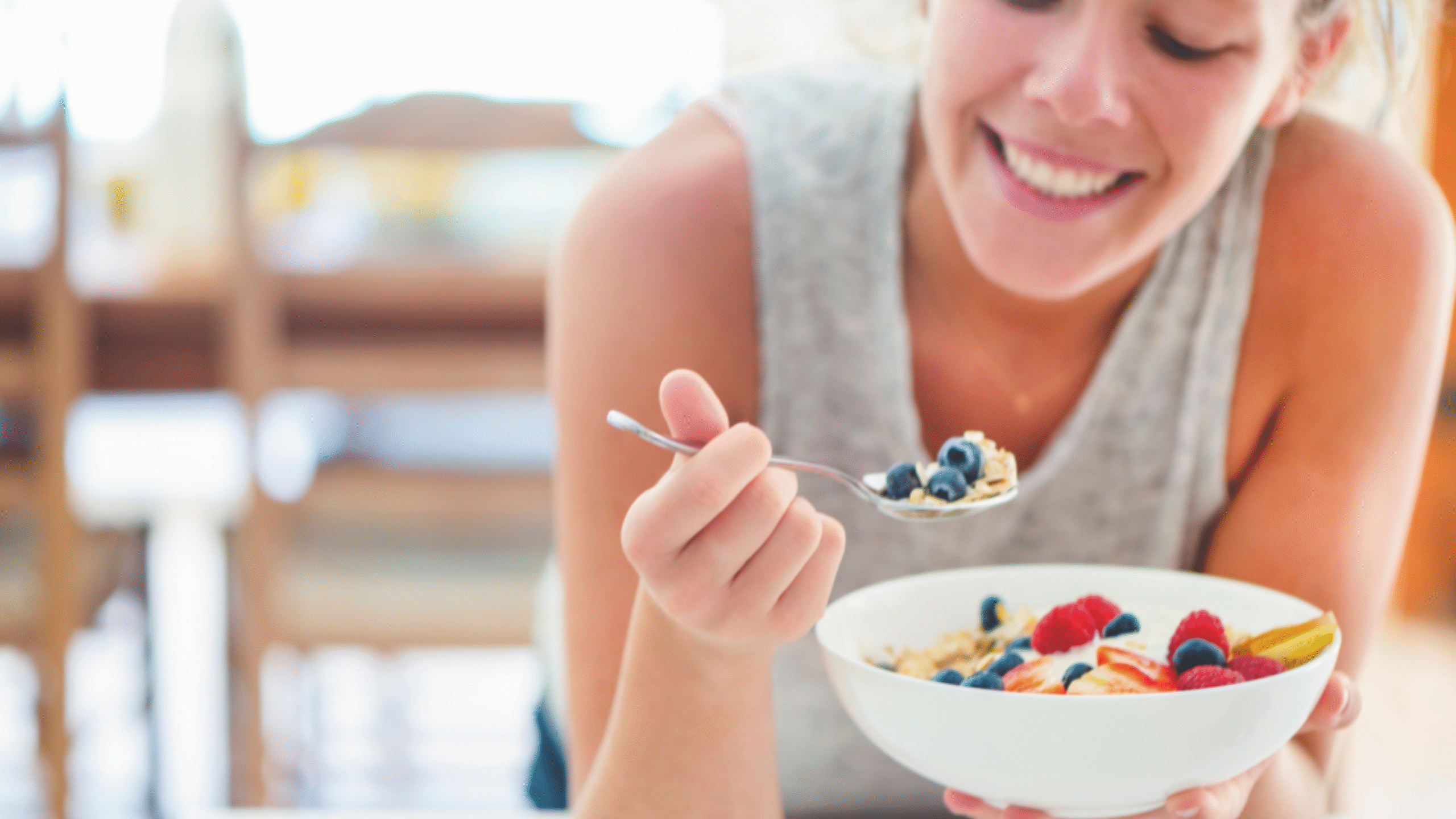 Woman eats healthy meal with a smile