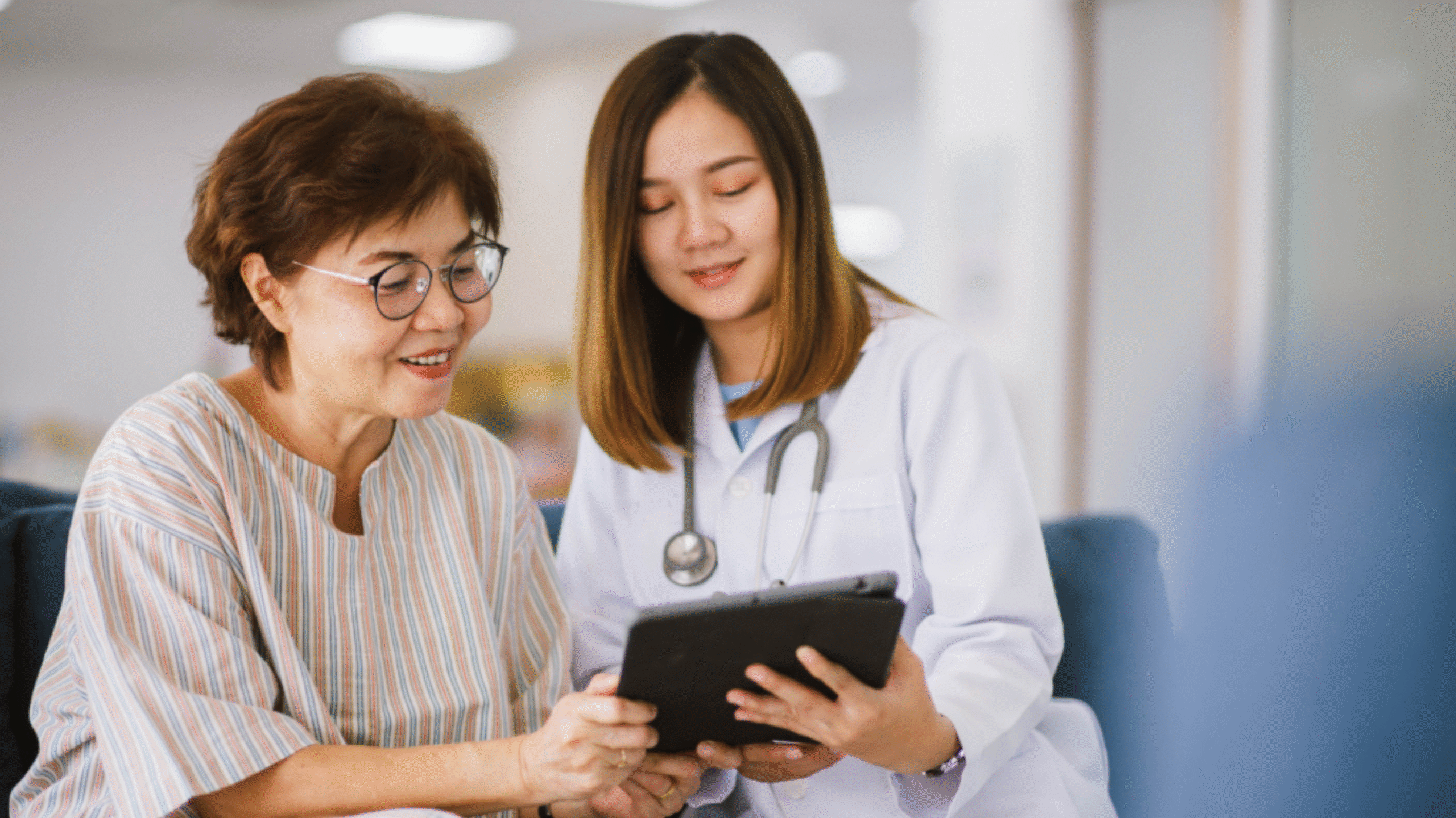 Doctor reviews health facts on tablet with patient