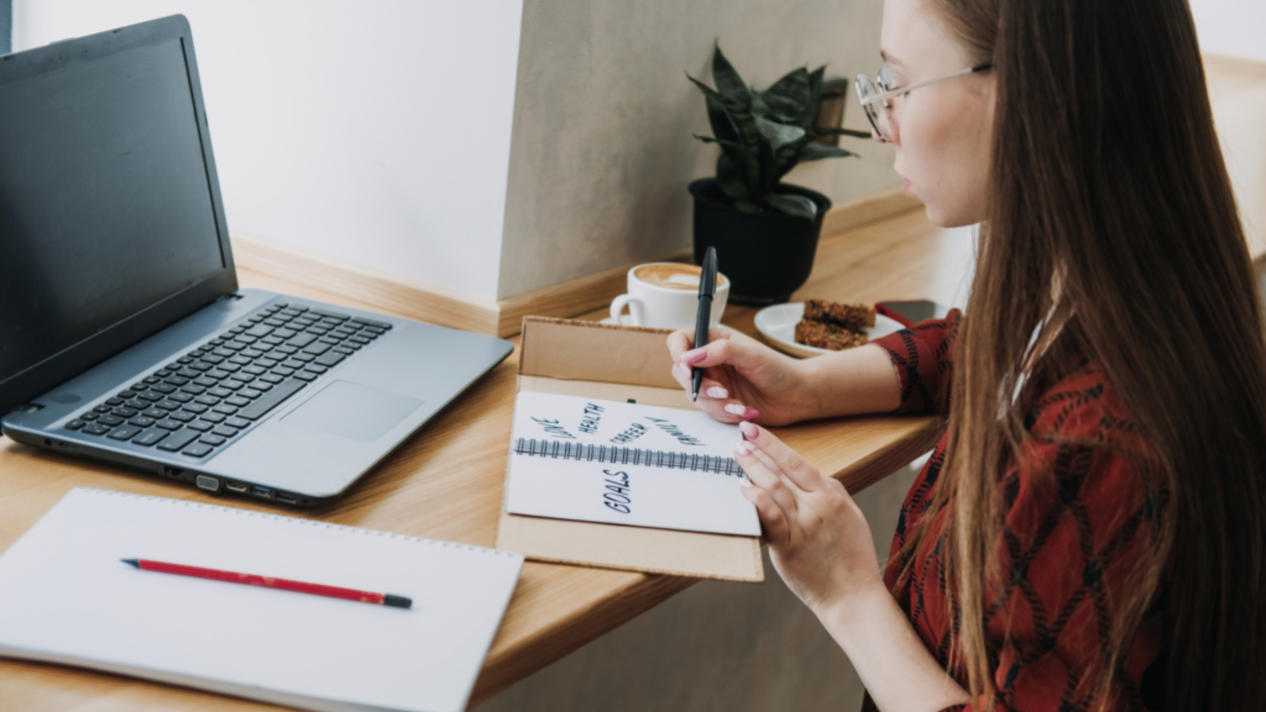 lady fills out calendar with goals for the new year