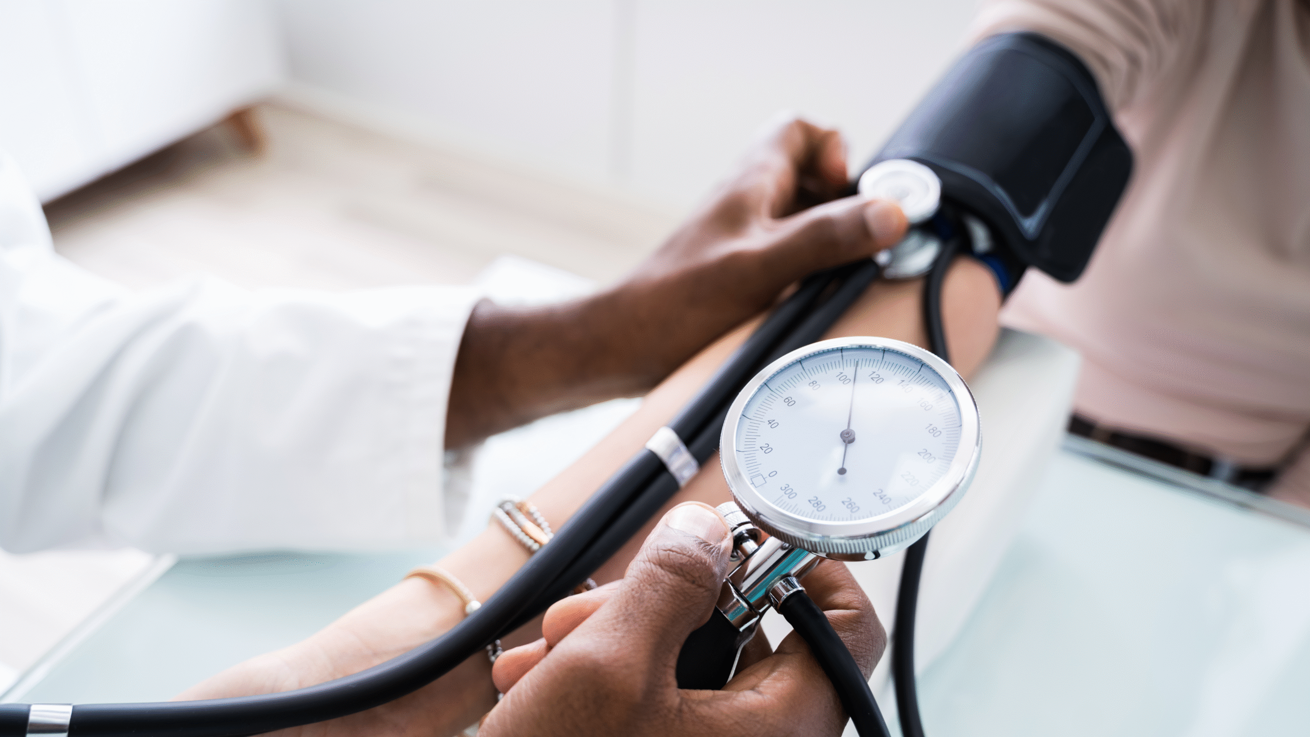 physician takes patient blood pressure reading
