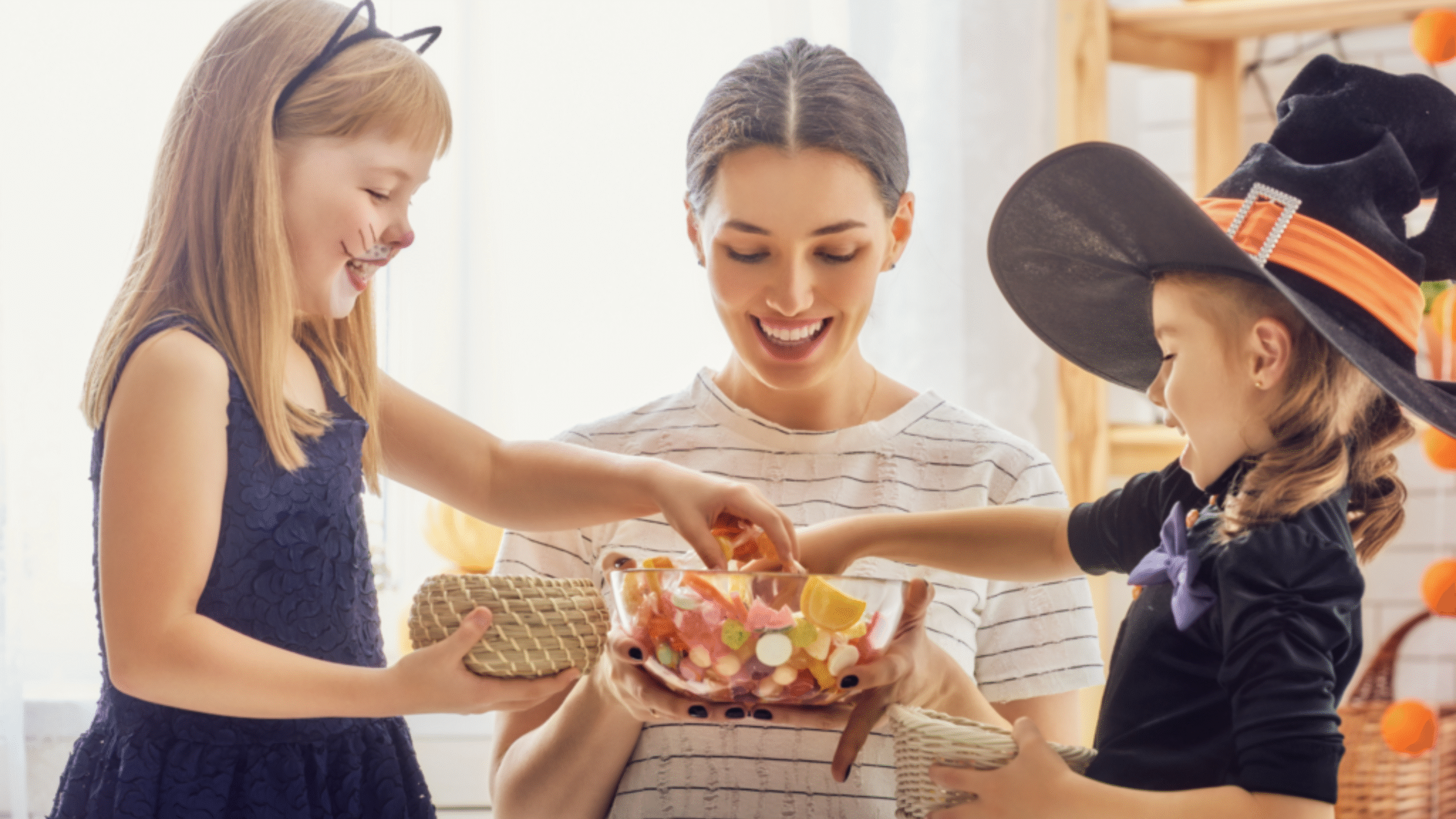 kids eating Halloween candy with their mom