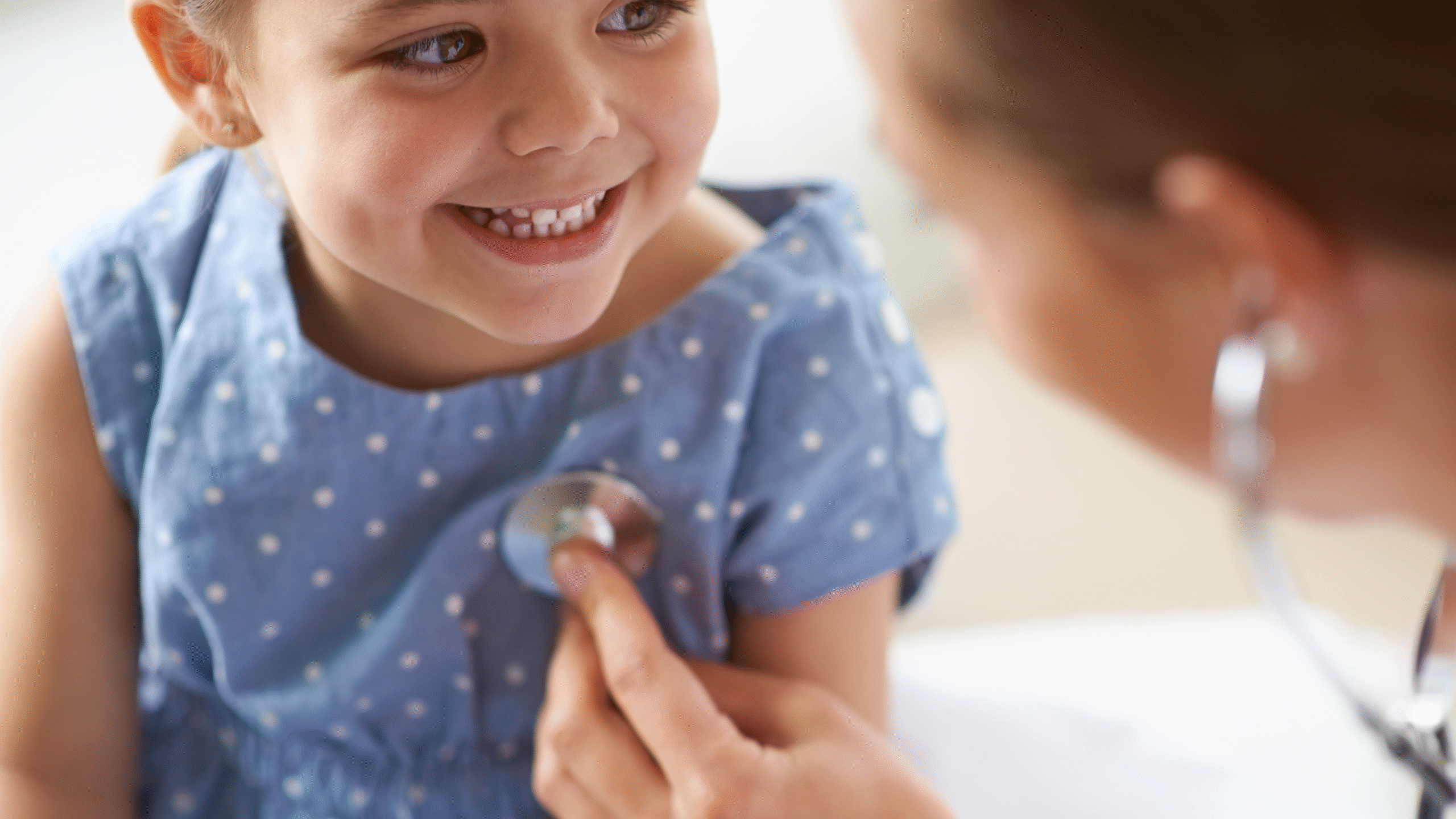 doctor listens to pediatric patient heart