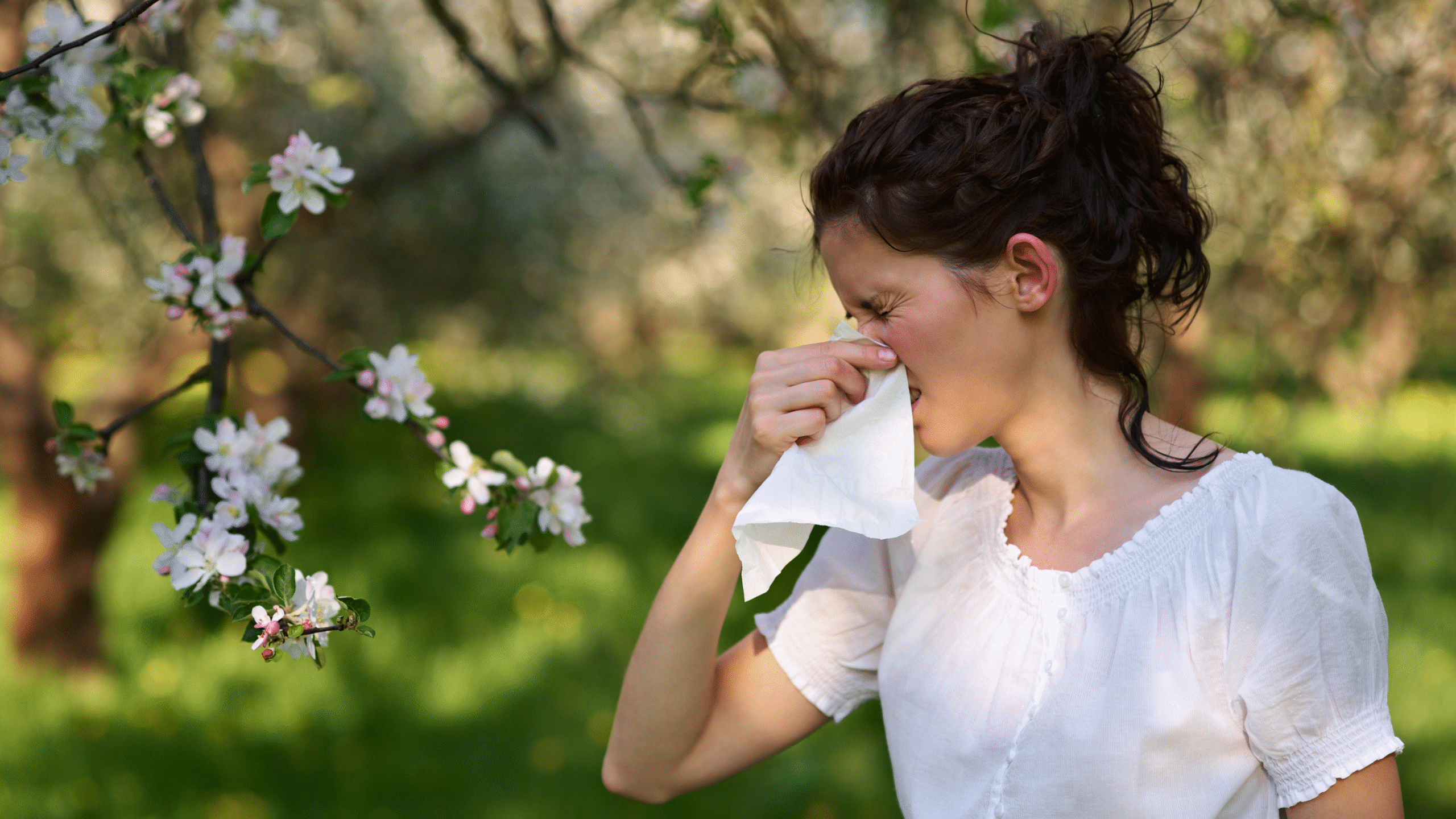 lady with sever allergies sneezing outside