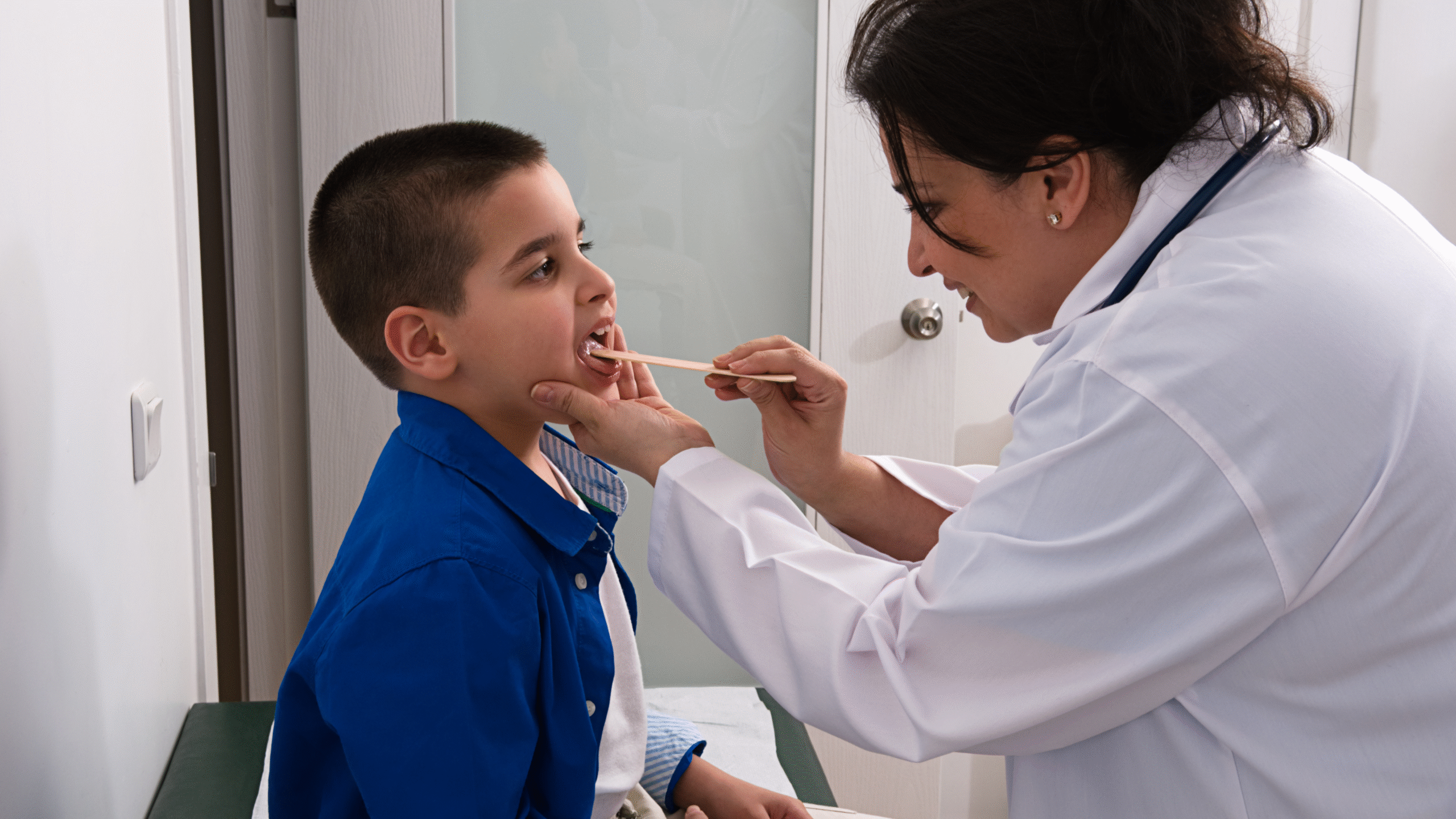 physician looks in back of Childs throat