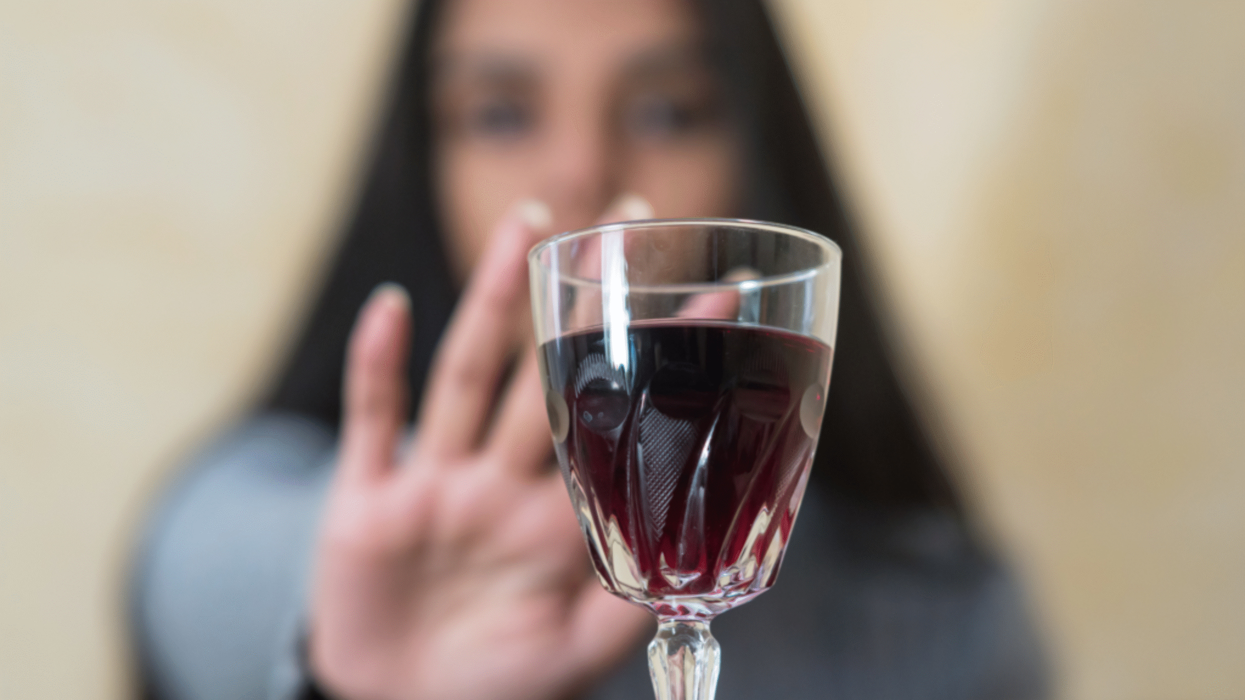 woman says no to red glass of wine